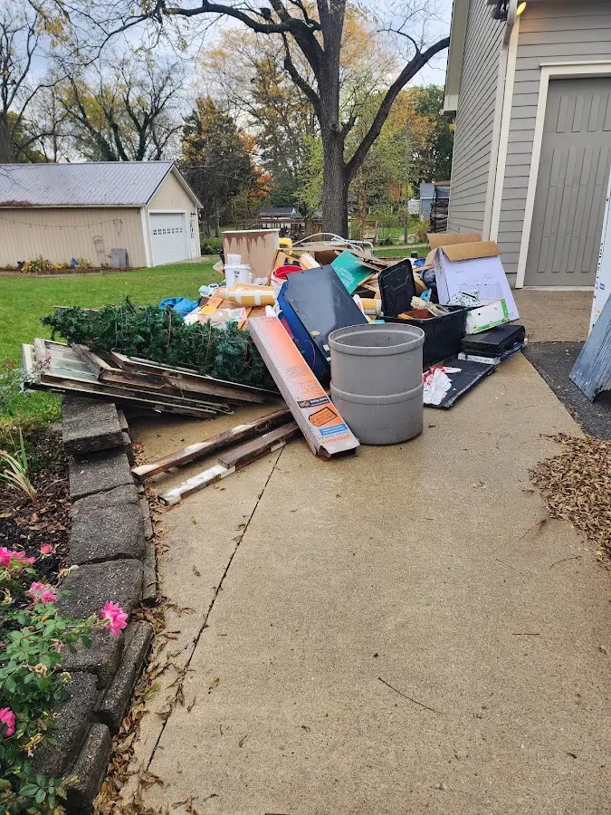 Dumpster being loaded with debris for Estate Cleanout Dumpster Rental in Livingston